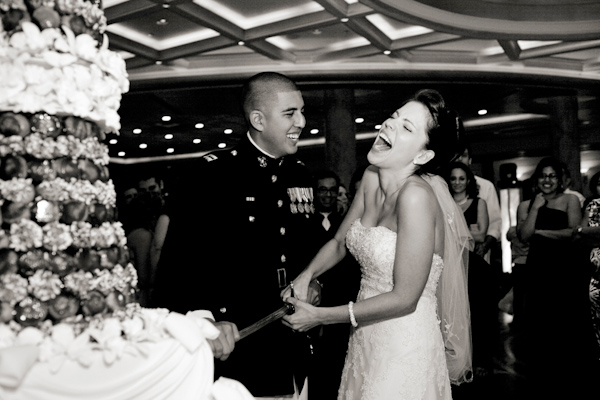 military bride and groom cutting their wedding cake with a sword - photo by New York based wedding photographer Merri Cry